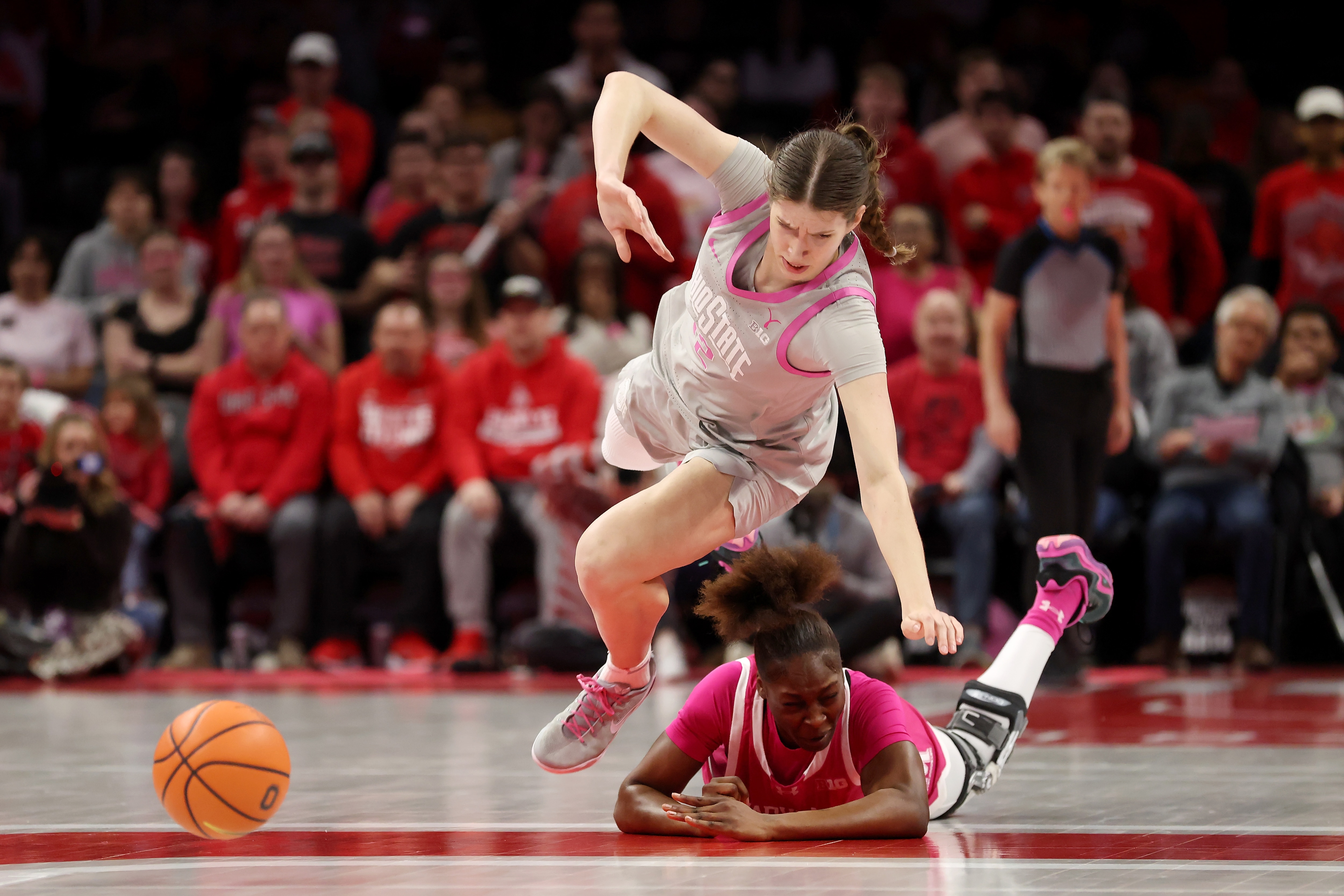 Elsa Lemmila, left, of Ohio State and Isimenme Ozzy-Momodu of Maryland chase a loose ball Sunday during the first quarter of the Terps’ 76-75 win.