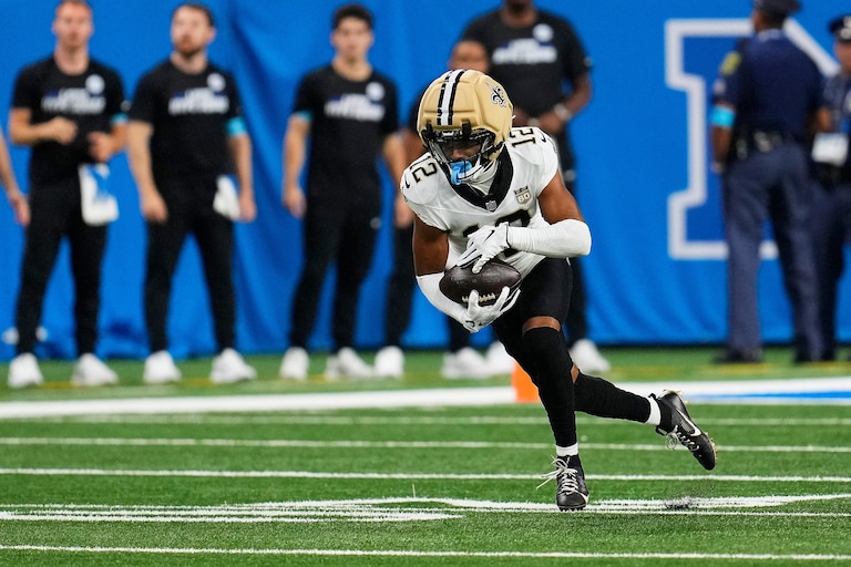 New Orleans Saints wide receiver Chris Olave (12) runs the ball after a pass reception against the Detroit Lions during an NFL football game Sunday, Sept. 13, 2026, in Detroit. (AP Photo/Paul Sancya)