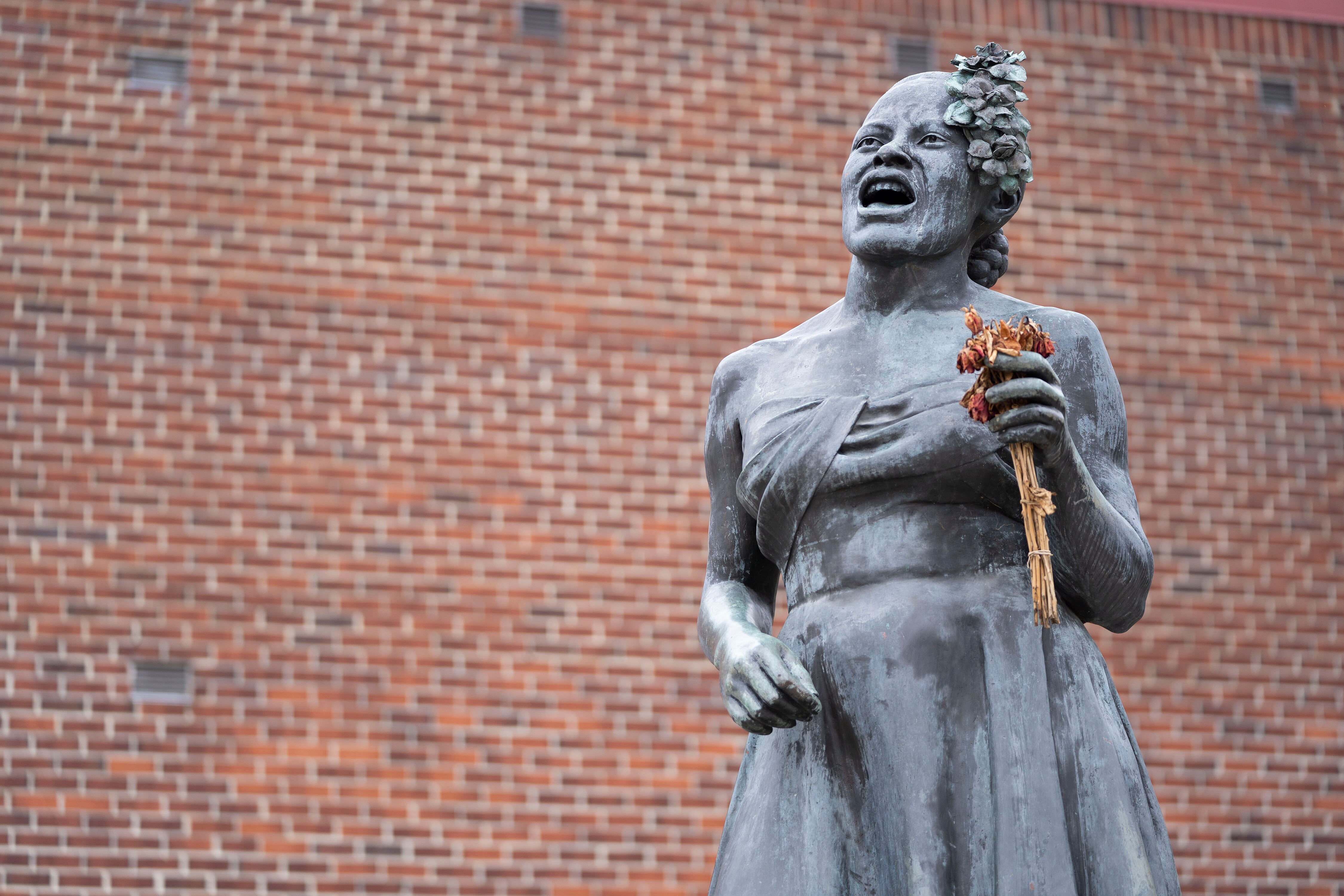 The Billie Holiday statue holds dry flowers near the intersection of Pennsylvania Avenue and West Lafayette Avenue.