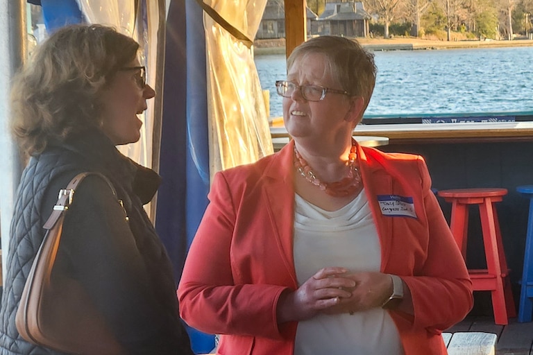 Tracy Starr, a Democratic candidate for Maryland’s 5th Congressional District, speaks with a voter at an April Anne Arundel County candidate forum.