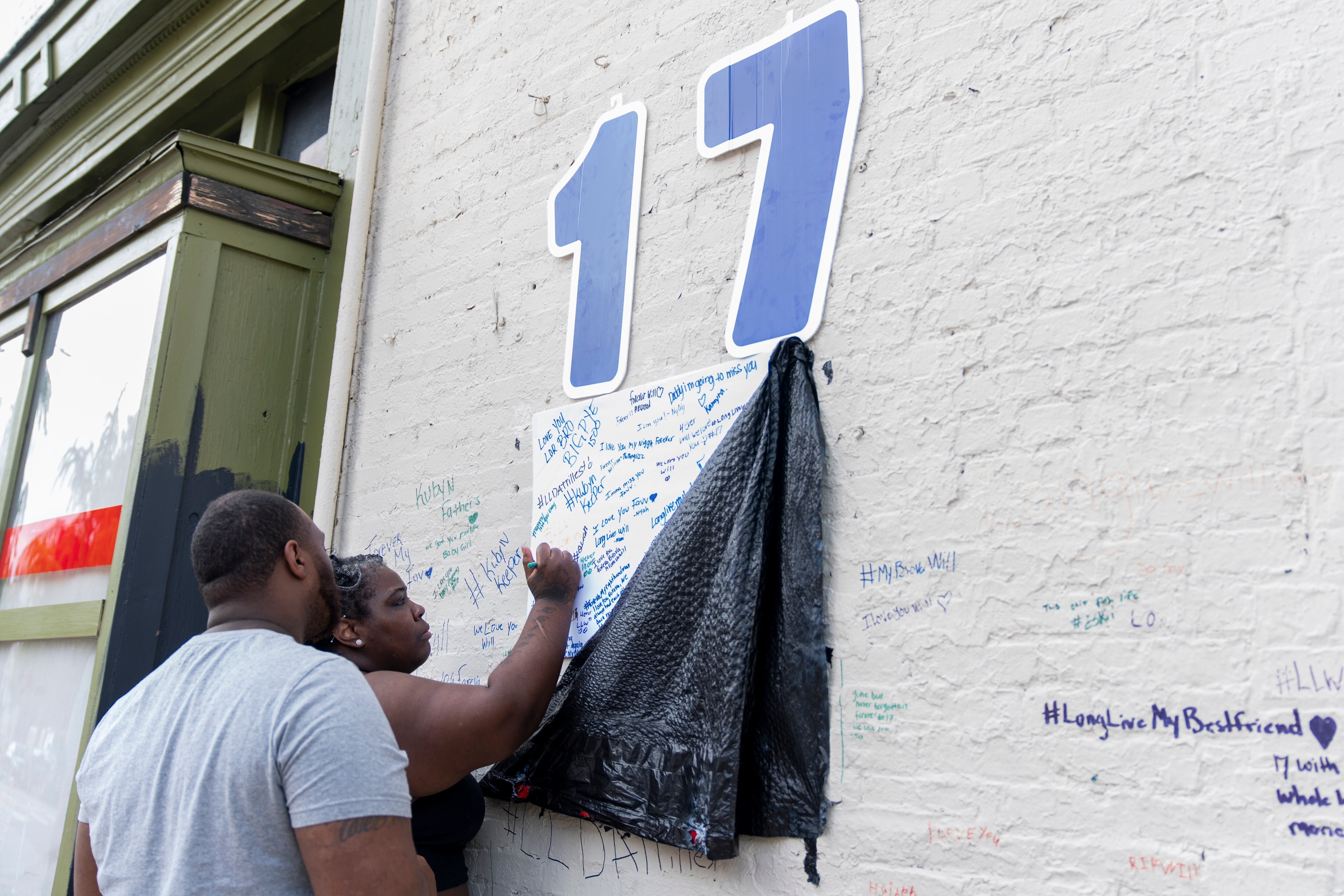 Myreshia Macon, the mother of a 17-year-old who was shot and killed by Baltimore police officers, right, visits a memorial for her son near the scene of the shooting in Baltimore, Wednesday, Aug. 7, 2024.
