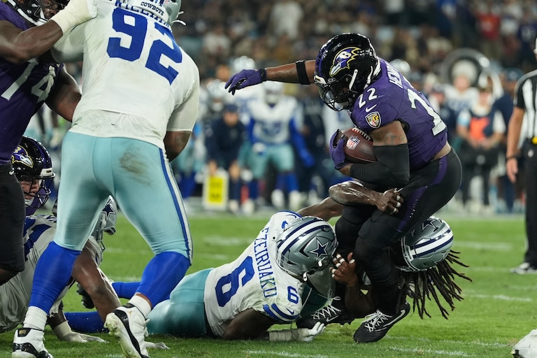 Baltimore Ravens running back Derrick Henry (22) is tackled by Dallas Cowboys linebacker Donovan Ezeiruaku (6) and linebacker Jaishawn Barham (55) during the second half of an NFL football game in Rio de Janeiro, Sunday, Sept. 27, 2026. (AP Photo/Fernando Llano)
