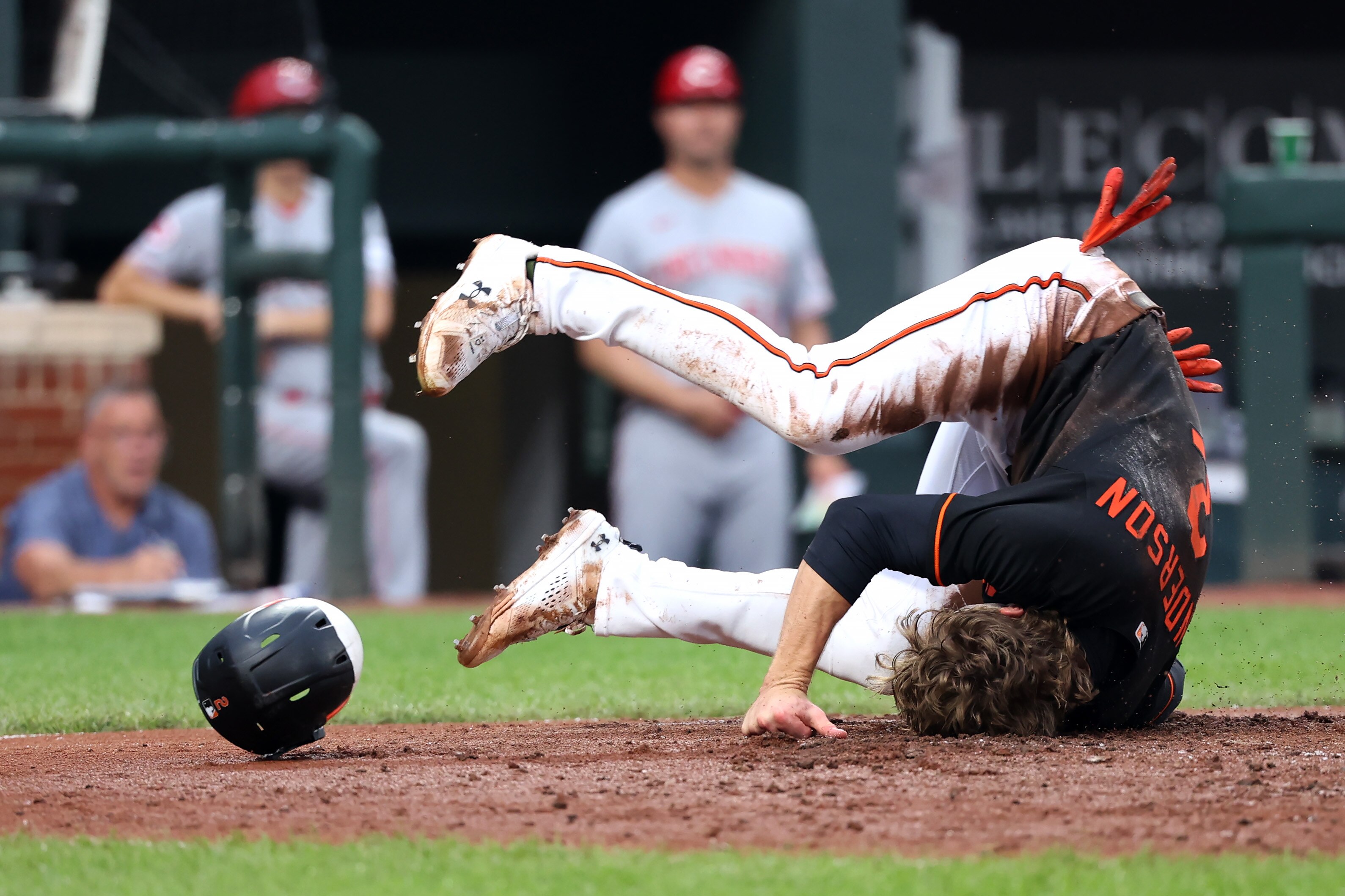 Orioles shortstop Gunnar Henderson tumbles after being thrown out at home plate in the first inning of Baltimore's 11-7, 10-inning loss to the Reds on Wednesday night at Camden Yards.