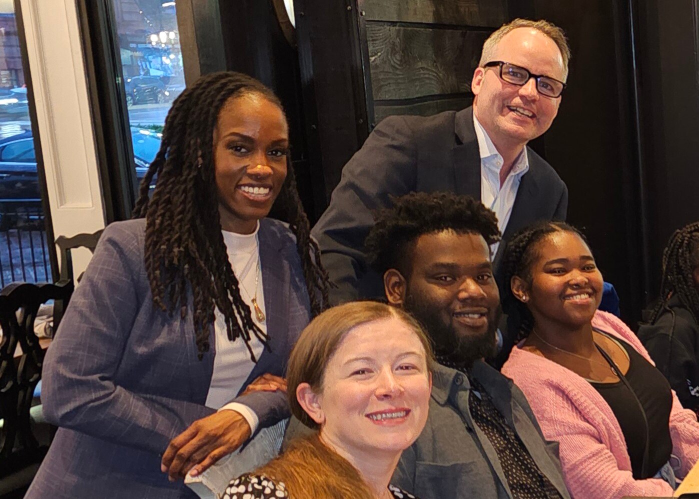 Jawone Nicholson, seated with his family, as trial counsel Cary Hansel and Tiana Boardman stand behind him.