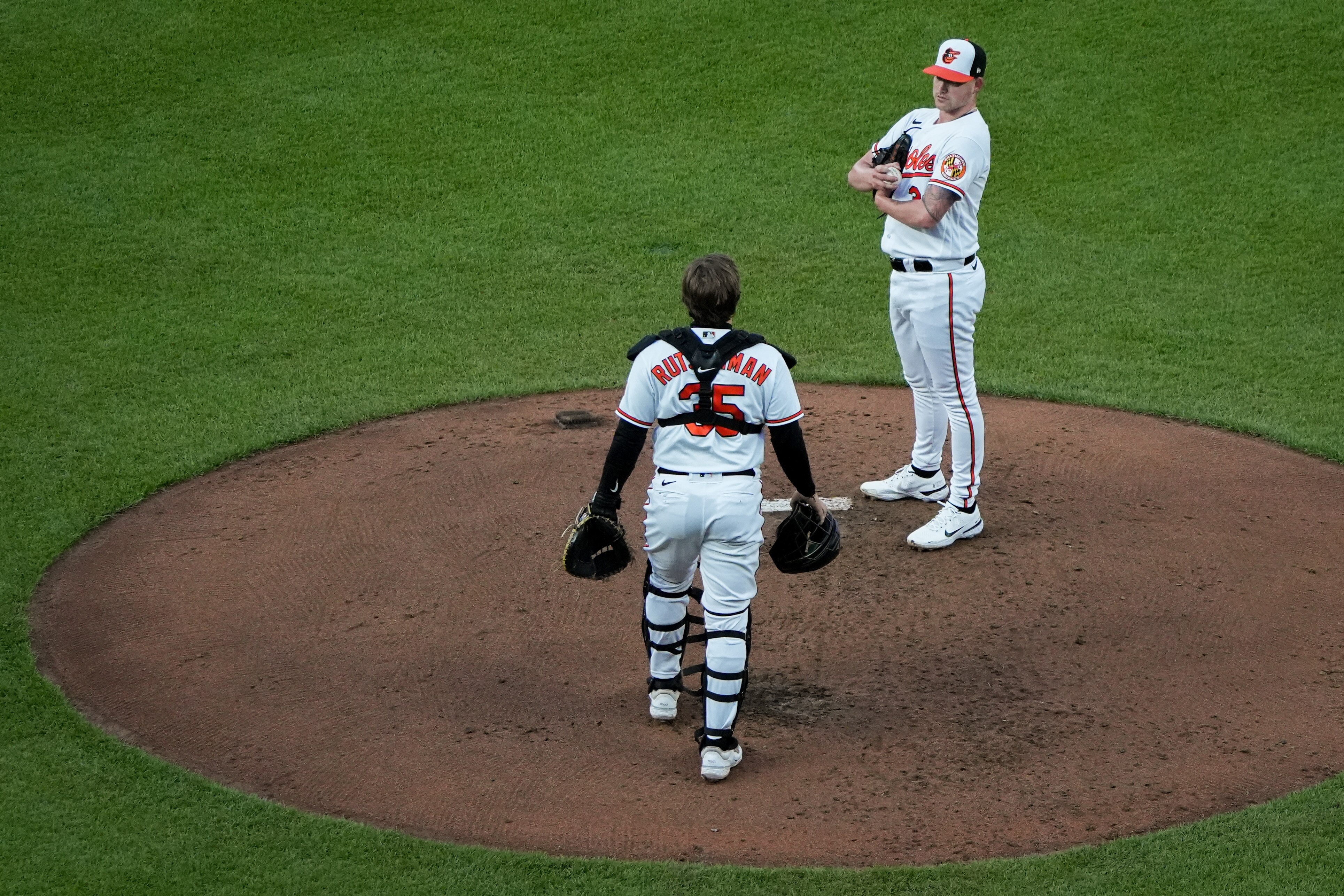 Baltimore Orioles catcher Adley Rutschman (35) joins starting pitcher Kyle Bradish (39) on the pitcher’s mound for a brief meeting in a baseball game against the Boston Red Sox at Camden Yards on Tuesday, April 25. The Orioles played the Red Sox in the second game of a 3-game series.