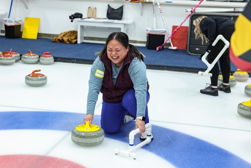 SATURDAY, FEBRUARY 21Β - First-time curler Catherine Carbullido White, 48, learns how to throw a curling stone during a Potomac Curling Club open house in Laurel, Md. Interest in the sport has grown following the recent 2026 Winter Olympics in Cortina, Italy, drawing new participants to the Maryland club.