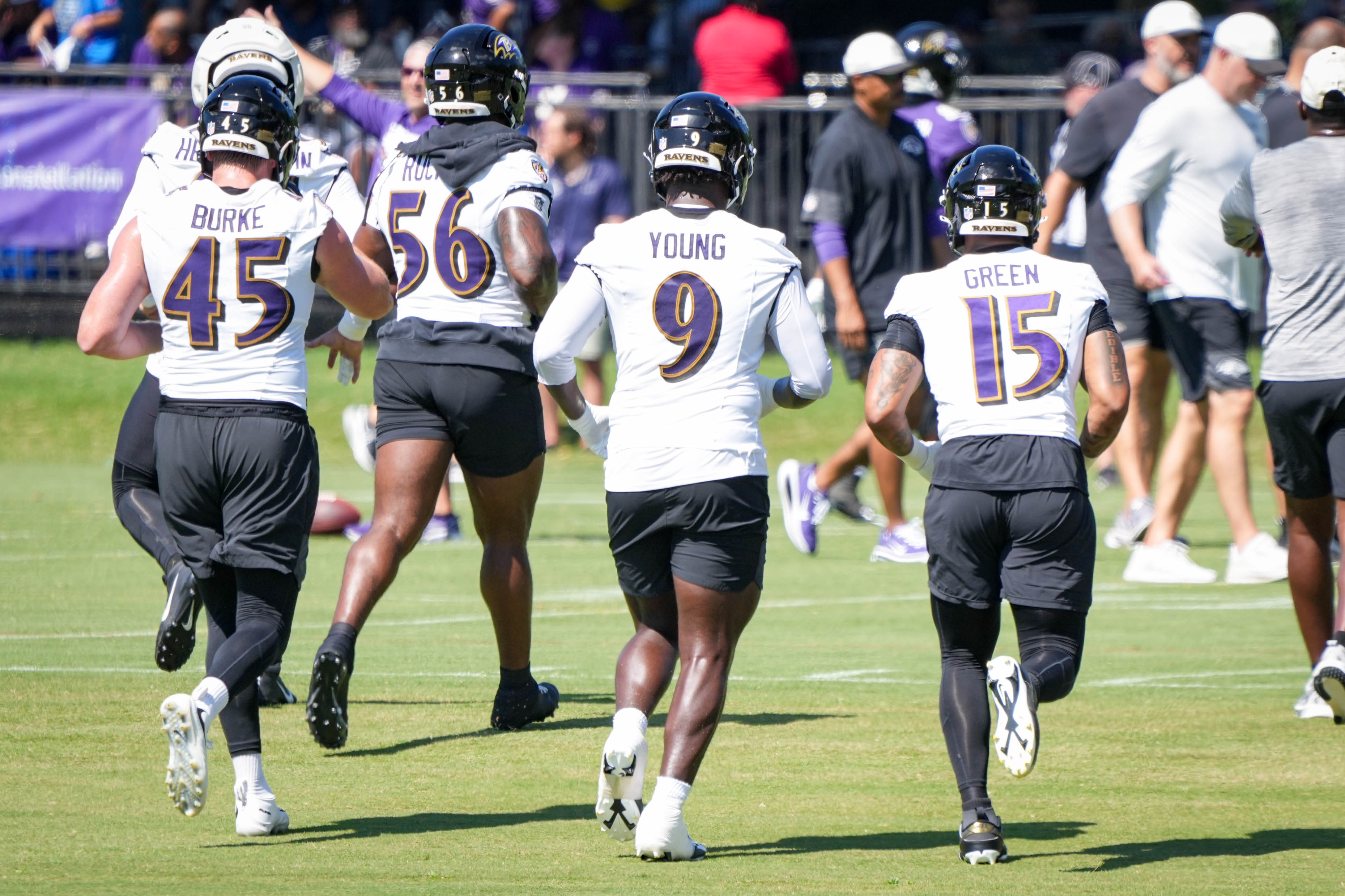 Ravens linebackers Ethan Burke, Kaimon Rucker, Zion Young and Mike Green participate in drills during training camp last week.