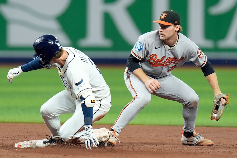 Tampa Bay Rays' Jonny DeLuca slides into second base with a two-run double ahead of the tag by Baltimore Orioles shortstop Gunnar Henderson, right, during the second inning of a baseball game Monday, May 18, 2026, in St. Petersburg, Fla.