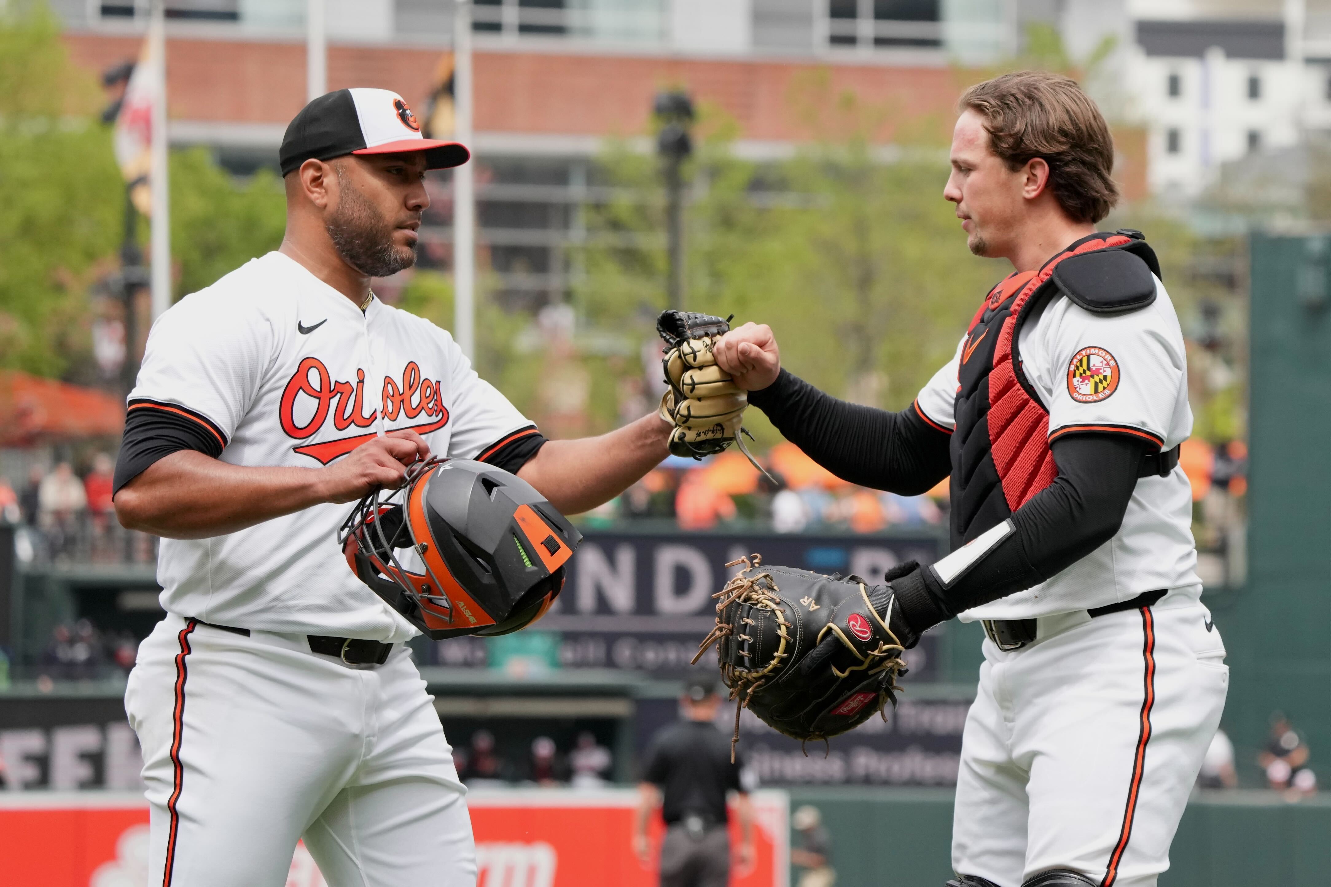 Starting pitcher Albert Suárez, left, and catcher Adley Rutschman fist bump at the end of an inning against the Minnesota Twins on April 17.