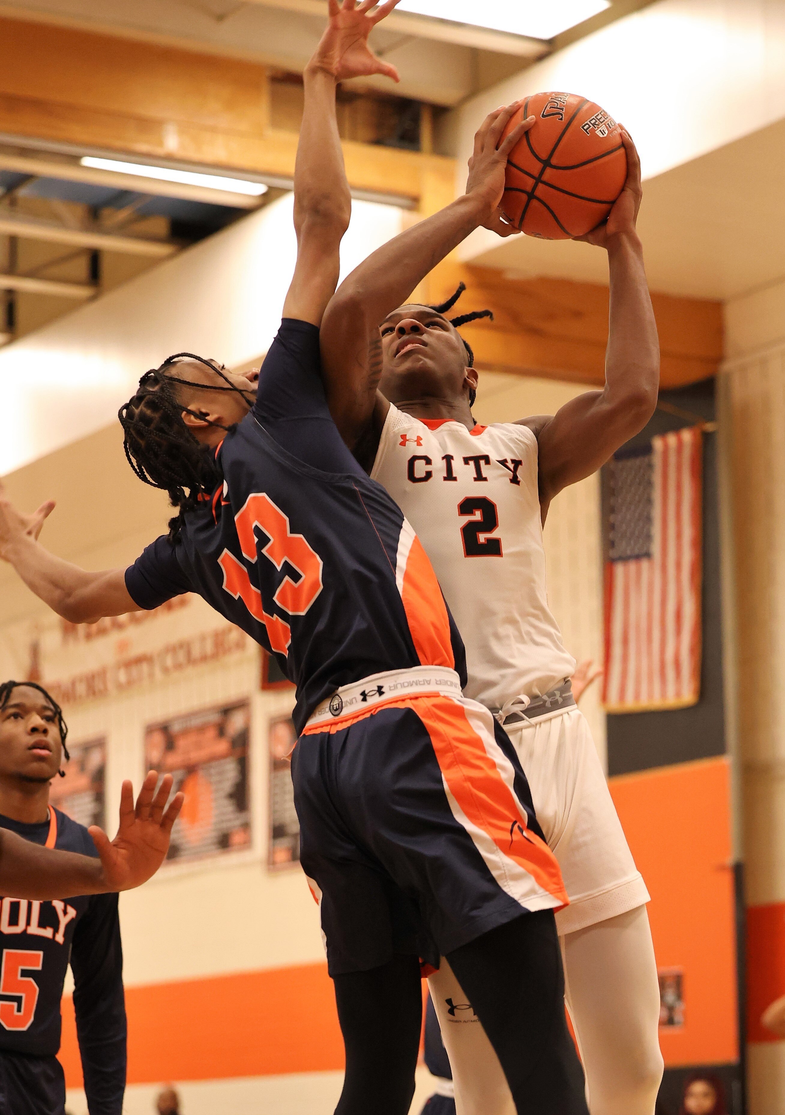 City forward Cam Horton (2) tries to shoot against Poly's Kenneth Estes during Thurdsay's Class 3A North Region I boys basketball championship. Horton finished with 25 points and 14 rebounds as the undefeated and No. 3 Knights won their second straight region crown with a 68-59 decision over the 12th-ranked Engineers in Baltimore City.