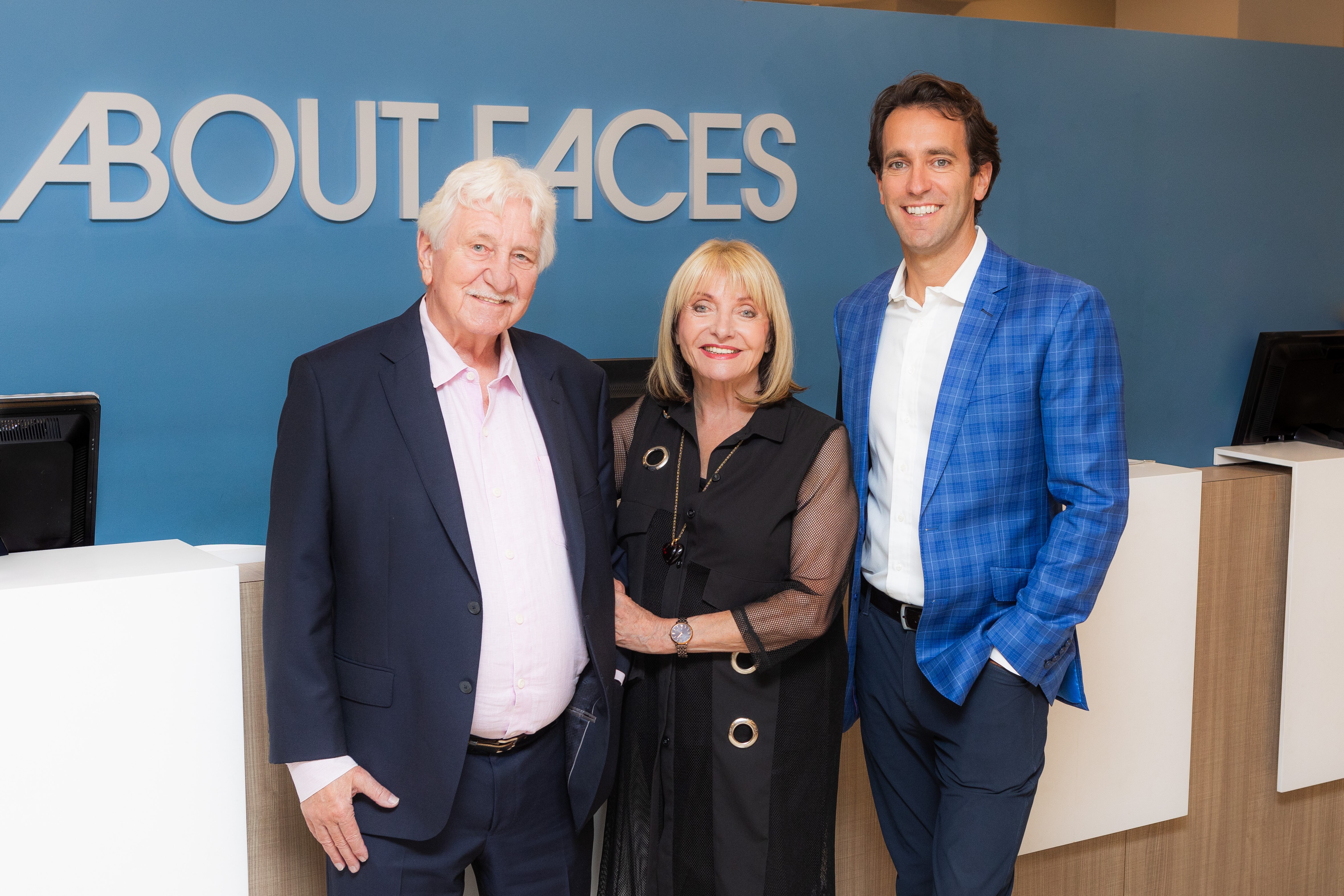 This is a photo of Patrick Brennan and Helga Surratt posing for a photo with Mackey Cronin, the new owner of About Faces Day Spa & Salon.