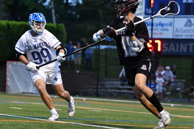Boys' Latin's Spencer Ford (right) is defended by St. Mary's longstick Dillon Torggler during Friday's MIAA A Conference lacrosse quarterfinal match.