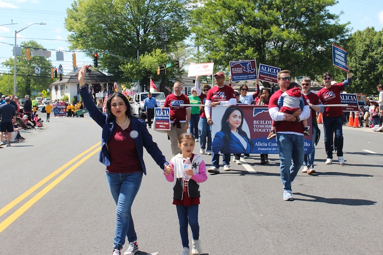 Alicia Contreras-Donello, a candidate for state delegate running to represent parts of Montgomery County, walks with her family and supporters in the Olney Days Parade in Olney on May 3.