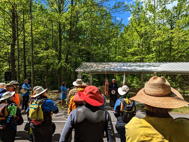 A dozen kayakers who paddled onto the beach at Beverly Triton Nature Park listen as Anne Arundel County Executive Steuart Pittman talks during dedication ceremonies Friday, May 5.