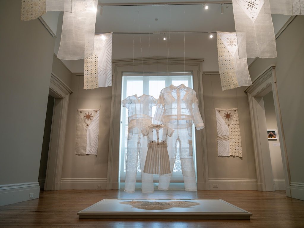 Baltimore artist Thea Canlas made uniforms and flags from embroidered piña cloth in her “Value Studies” series, shown here at the Walters Art Museum’s Hackerman House.