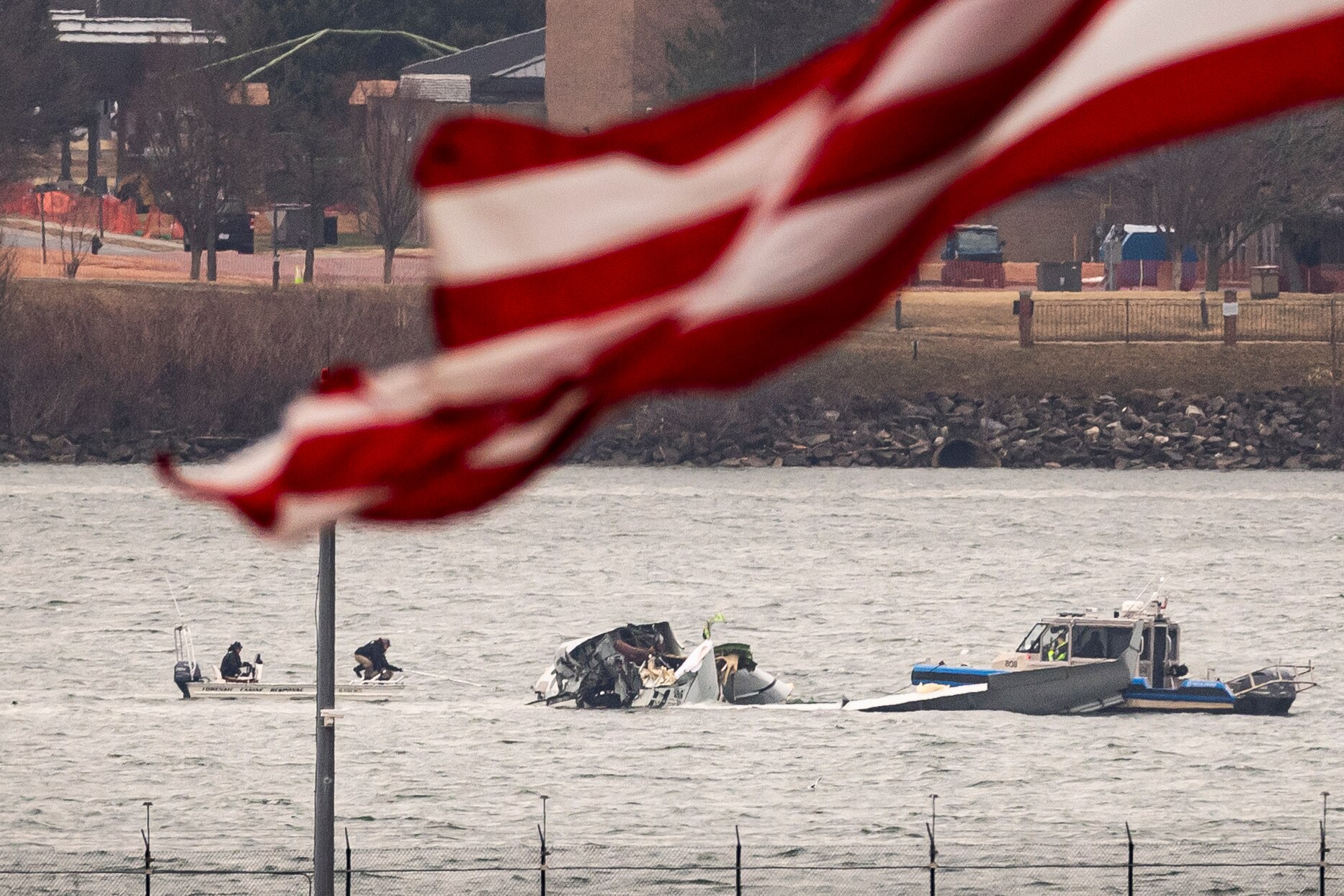 ARLINGTON, VIRGINIA - JANUARY 31: Recovery teams search the wreckage after the crash of an American Airlines plane on the Potomac River as it approached the airport on January 31, 2025 in Arlington, Virginia. The American Airlines flight from Wichita, Kansas collided midair with a military Black Hawk helicopter while on approach to Ronald Reagan Washington National Airport. According to reports, there were no survivors among the 67 people on both aircraft.