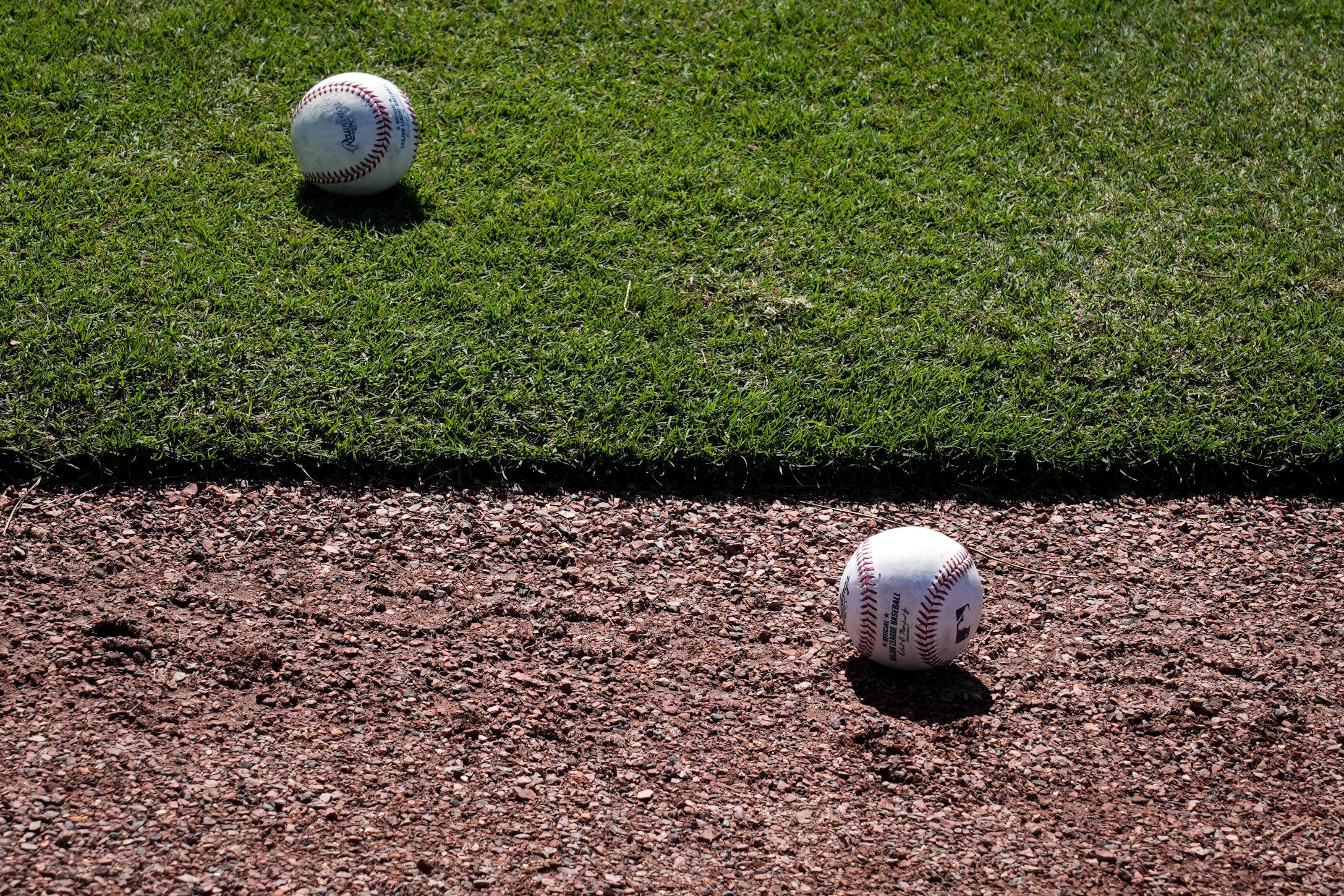 Two baseballs rest on the field at Ed Smith Stadium in Sarasota on 2/22/23. The Baltimore Orioles’ Spring Training session runs from mid-February through the end of March.