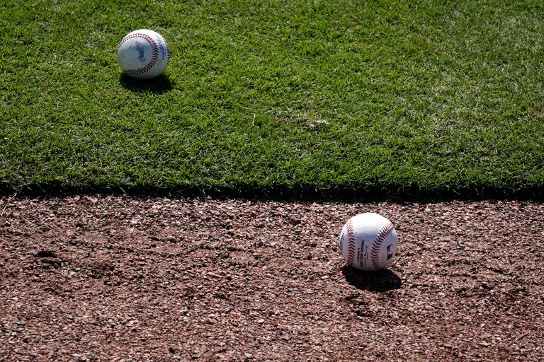 Two baseballs rest on the field at Ed Smith Stadium in Sarasota on 2/22/23. The Baltimore Orioles’ Spring Training session runs from mid-February through the end of March.