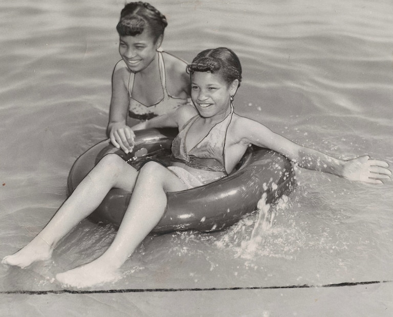 Gloria Lewis, 14, and Marilyn Lewis, 10,
sisters from Marrifield, Md., enjoy themselves at Carr's Beach on July 16, 1957. Gelatin silver print.