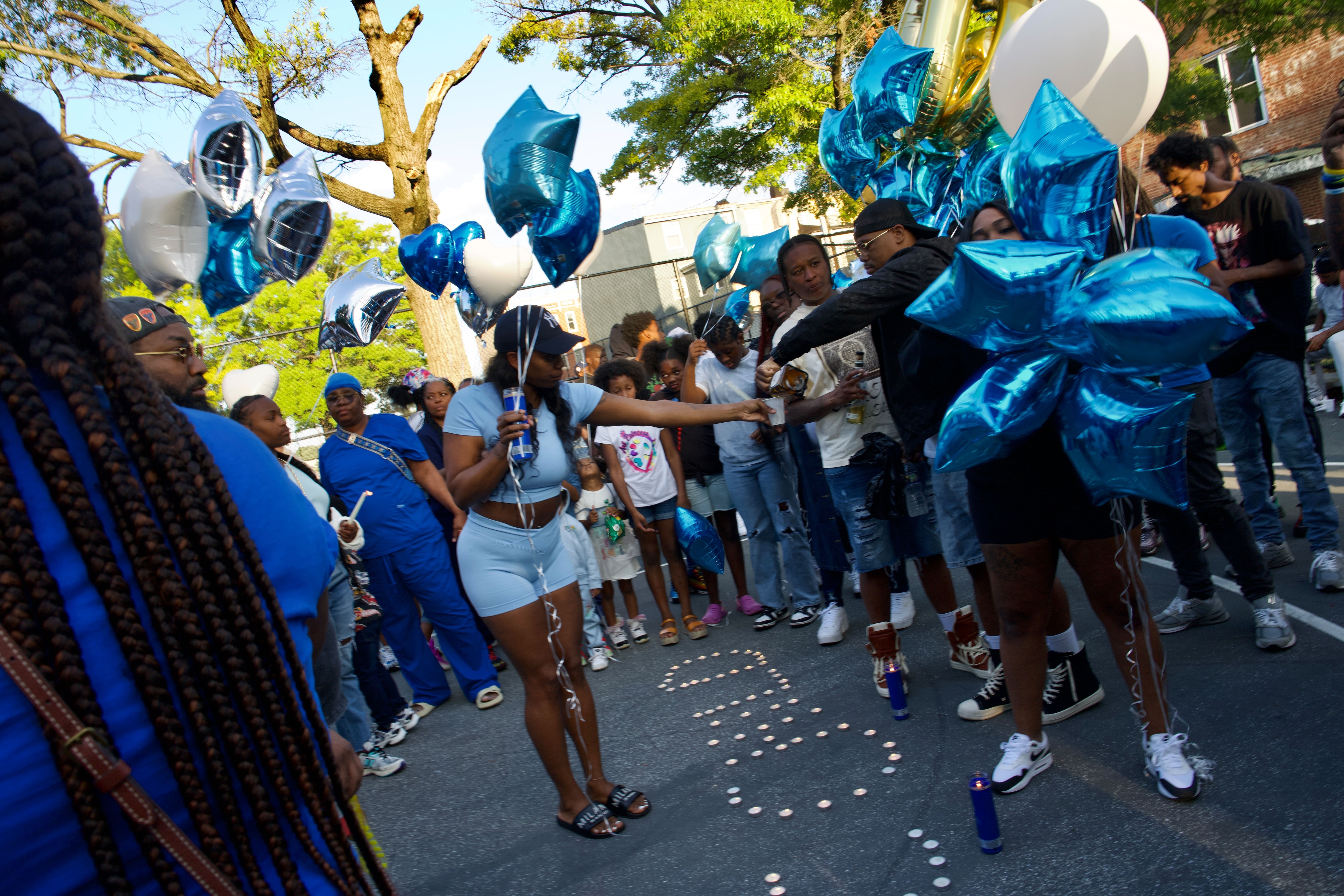 Upwards of one hundred people gathered on the basketball courts to honor and celebrate the life of Anthony “Chris” Martin including his cousins, brother and fiancé. They shared shots of Patron and Hennessy and released white, blue and silver balloons into the sky that floated above the now burned down motorcycle club. Baltimore Police say the fire at the motorcycle club may have been retaliation for the shooting.