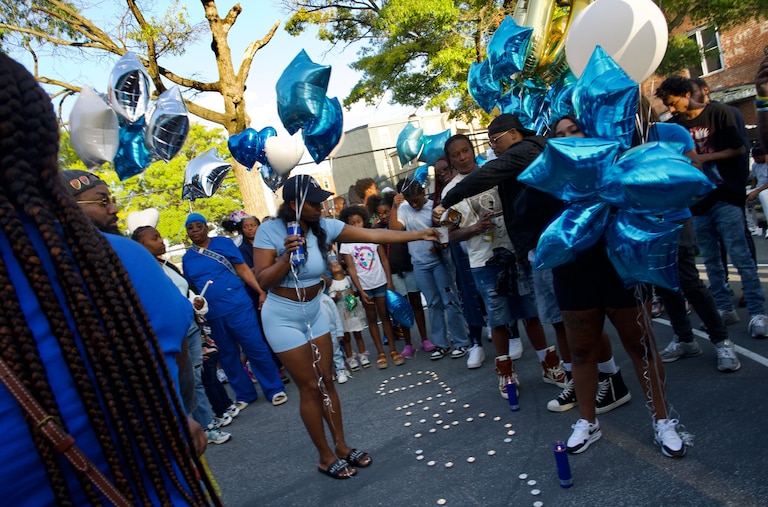Upwards of one hundred people gathered on the basketball courts to honor and celebrate the life of Anthony “Chris” Martin including his cousins, brother and fiancé. They shared shots of Patron and Hennessy and released white, blue and silver balloons into the sky that floated above the now burned down motorcycle club. Baltimore Police say the fire at the motorcycle club may have been retaliation for the shooting.