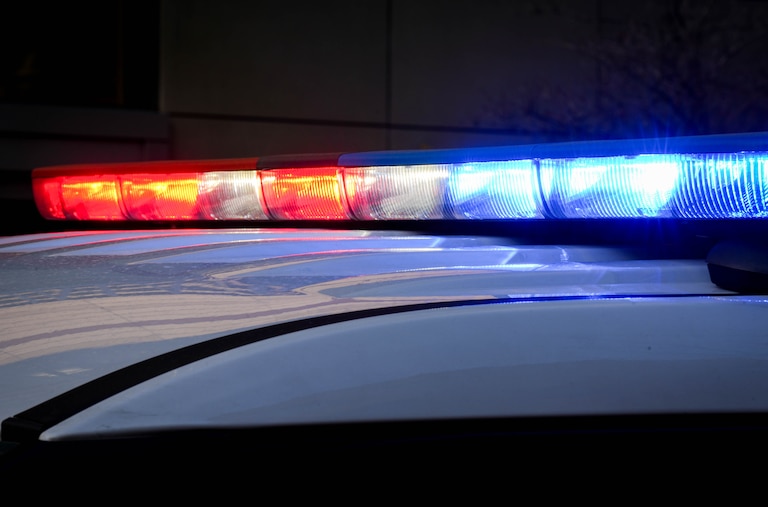 A Baltimore County police vehicle’s lights flash while parked outside of the R Adams Cowley Shock Trauma Center at the University of Maryland in Baltimore, Md. on Thursday, March 13, 2025.