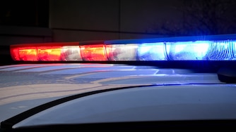 A Baltimore County police vehicle’s lights flash while parked outside of the R Adams Cowley Shock Trauma Center at the University of Maryland in Baltimore, Md. on Thursday, March 13, 2025.