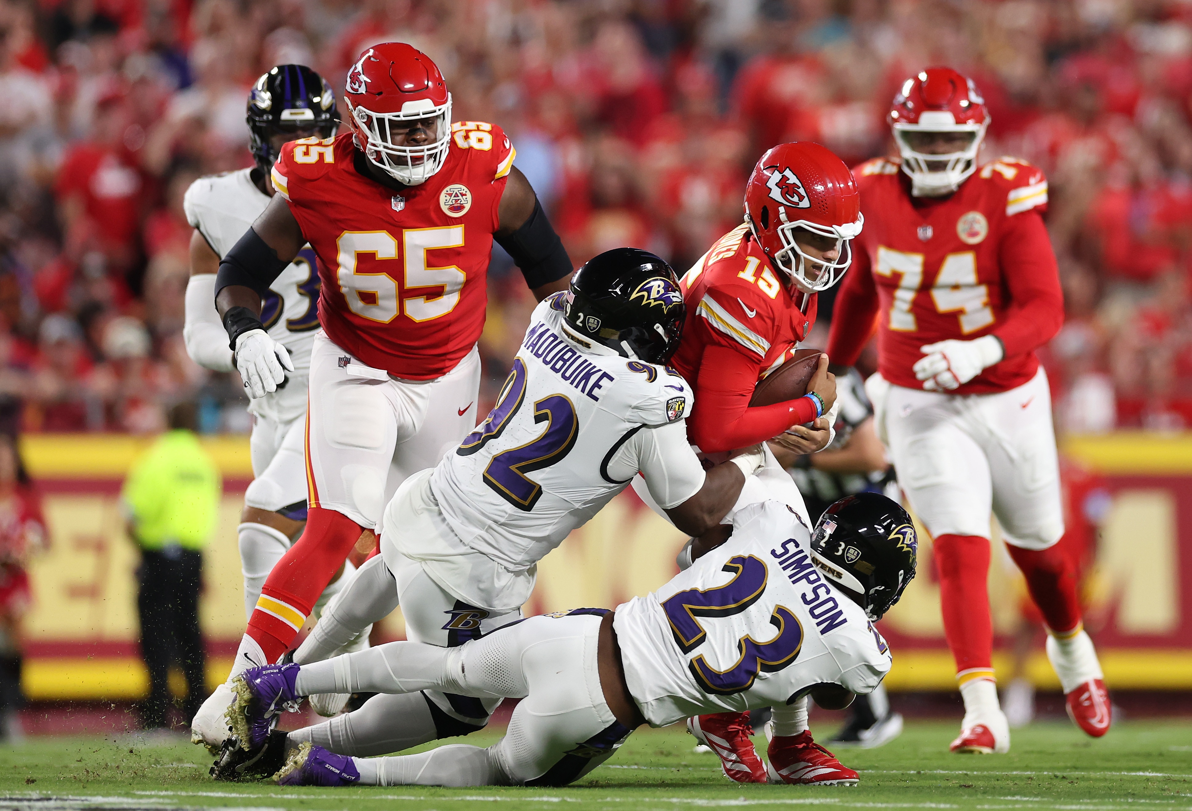 The Ravens’ Nnamdi Madubuike and Trenton Simpson take down Chiefs quarterback Patrick Mahomes.
