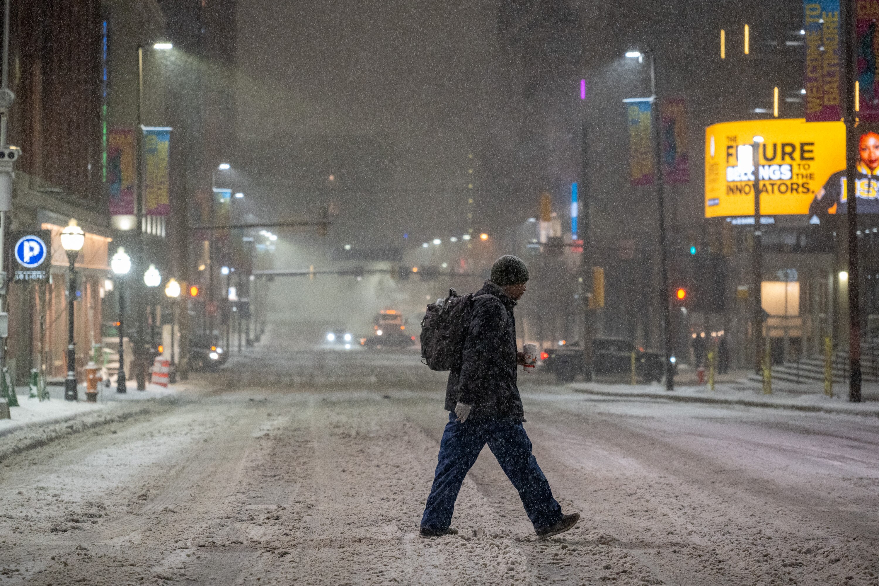 A pedestrian crosses Lombard Street early Monday as a winter storm blankets the region.
