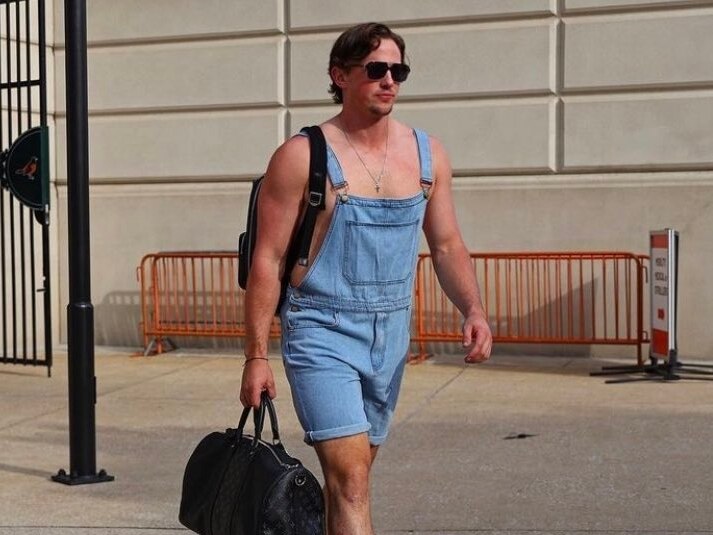 This picture shows Orioles catcher Adley Rutschman wearing denim overalls.