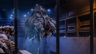 A giant claw moves garbage around the room where the waste is held at the Montgomery County resource recovery facility on Wednesday September 17th. Waste needs to be periodically moved around in order to keep the organic material that is decomposing and generating heat from creating a fire in the facility.