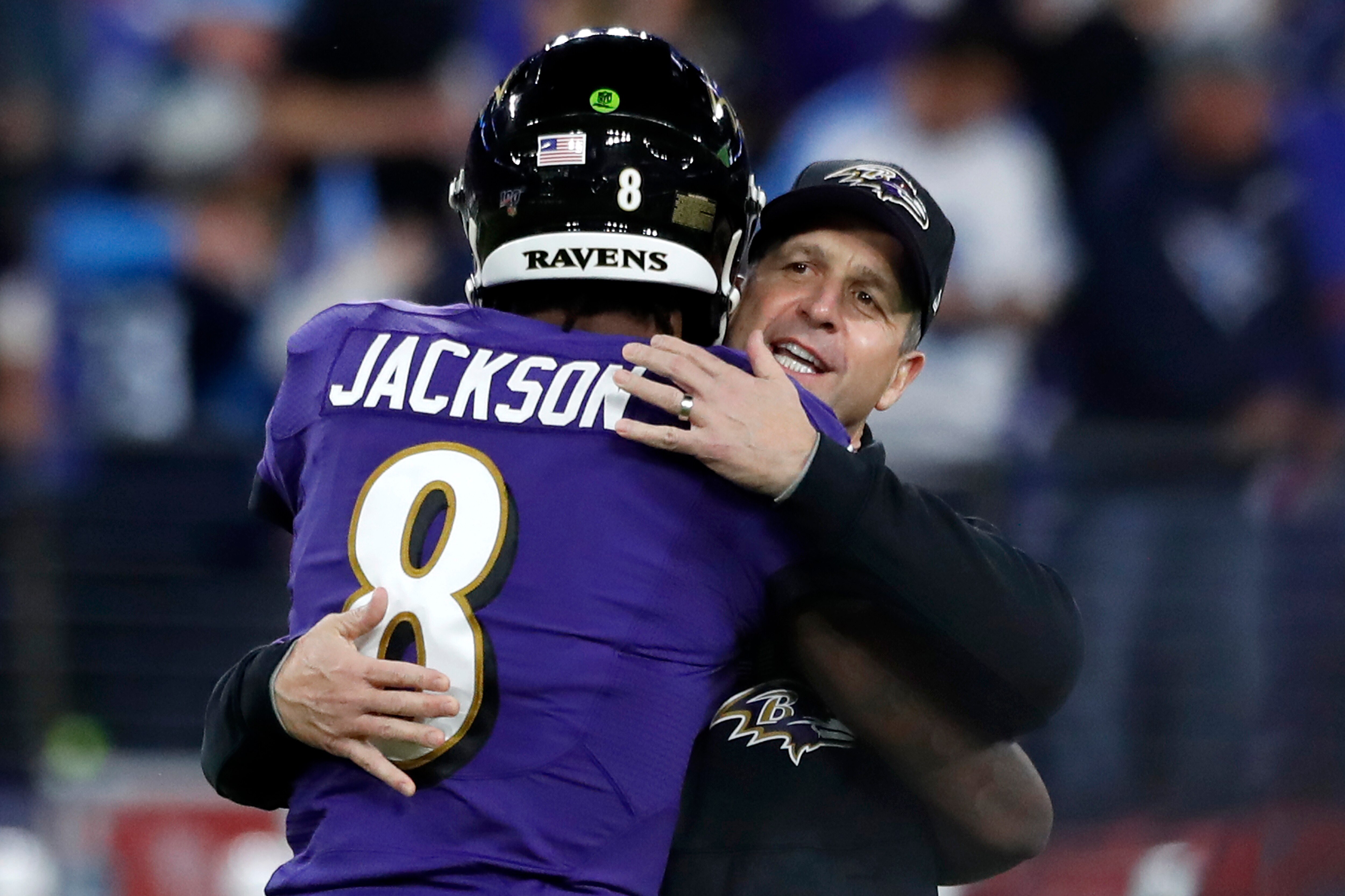 Head coach John Harbaugh of the Baltimore Ravens and quarterback Lamar Jackson #8 embrace prior to the AFC Divisional Playoff game against the Tennessee Titans at M&T Bank Stadium on January 11, 2020 in Baltimore, Maryland.