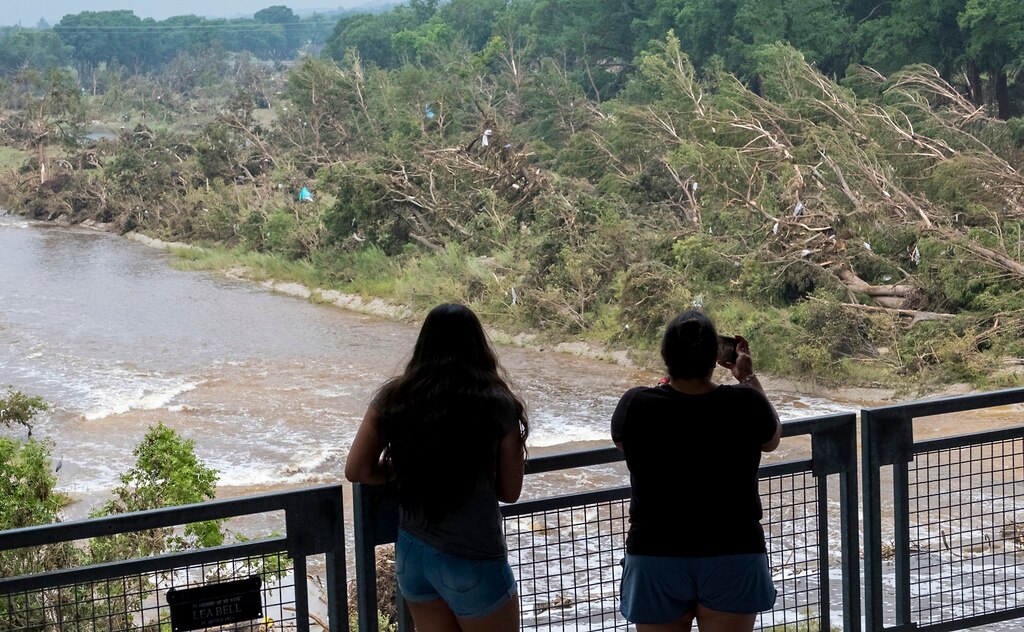 Onlookers review the damage along the Guadalupe River caused by recent flooding, Sunday, July 6, 2025, in Kerrville, Texas.