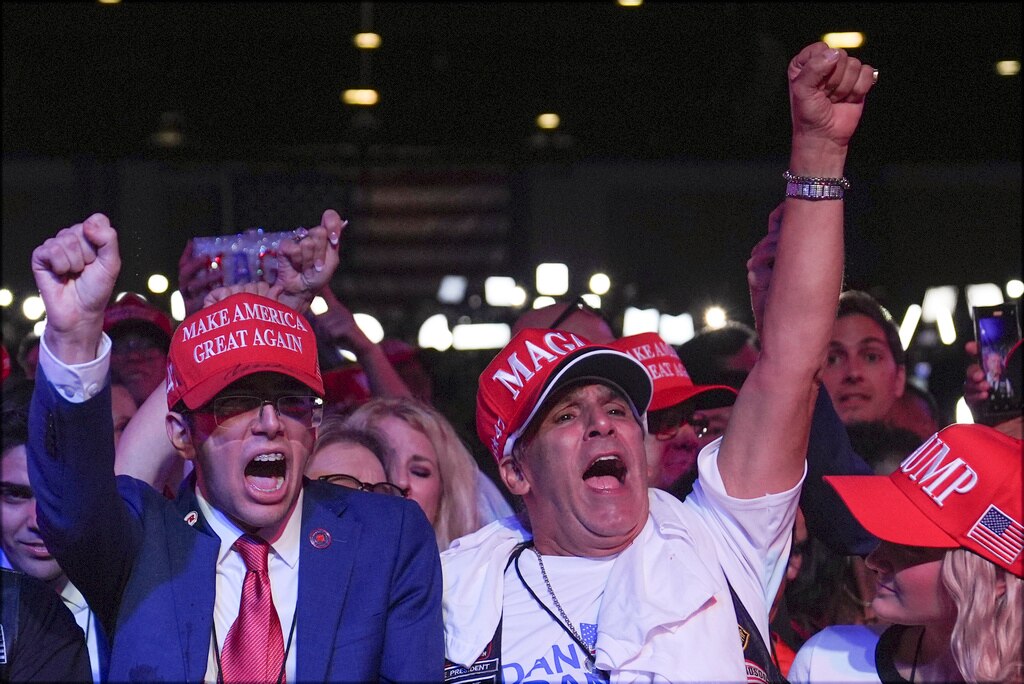 Supporters cheering at an election night watch party for Donald Trump.