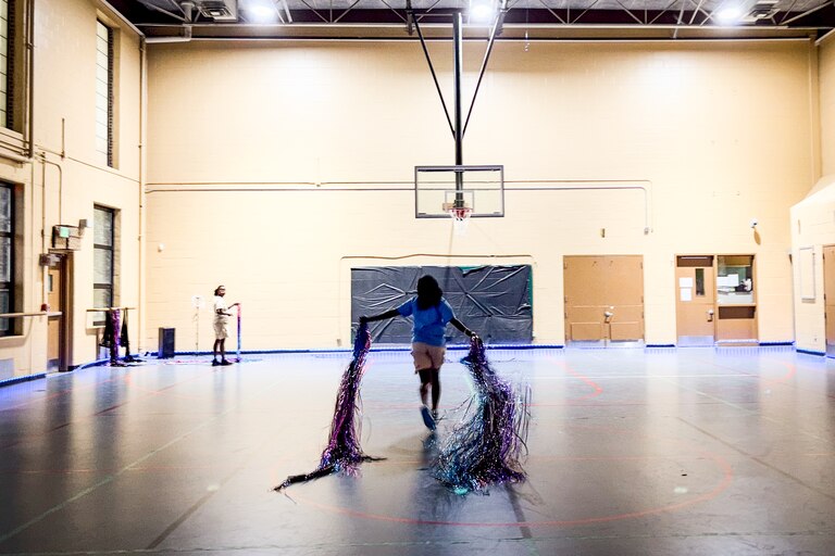 Amaira Small, who works in teen engagement for the Recreation & Parks Department, takes down decorations in the gymnasium after the TikTok party at the Farring Baybrook Recreation Center on June 13, 2025.