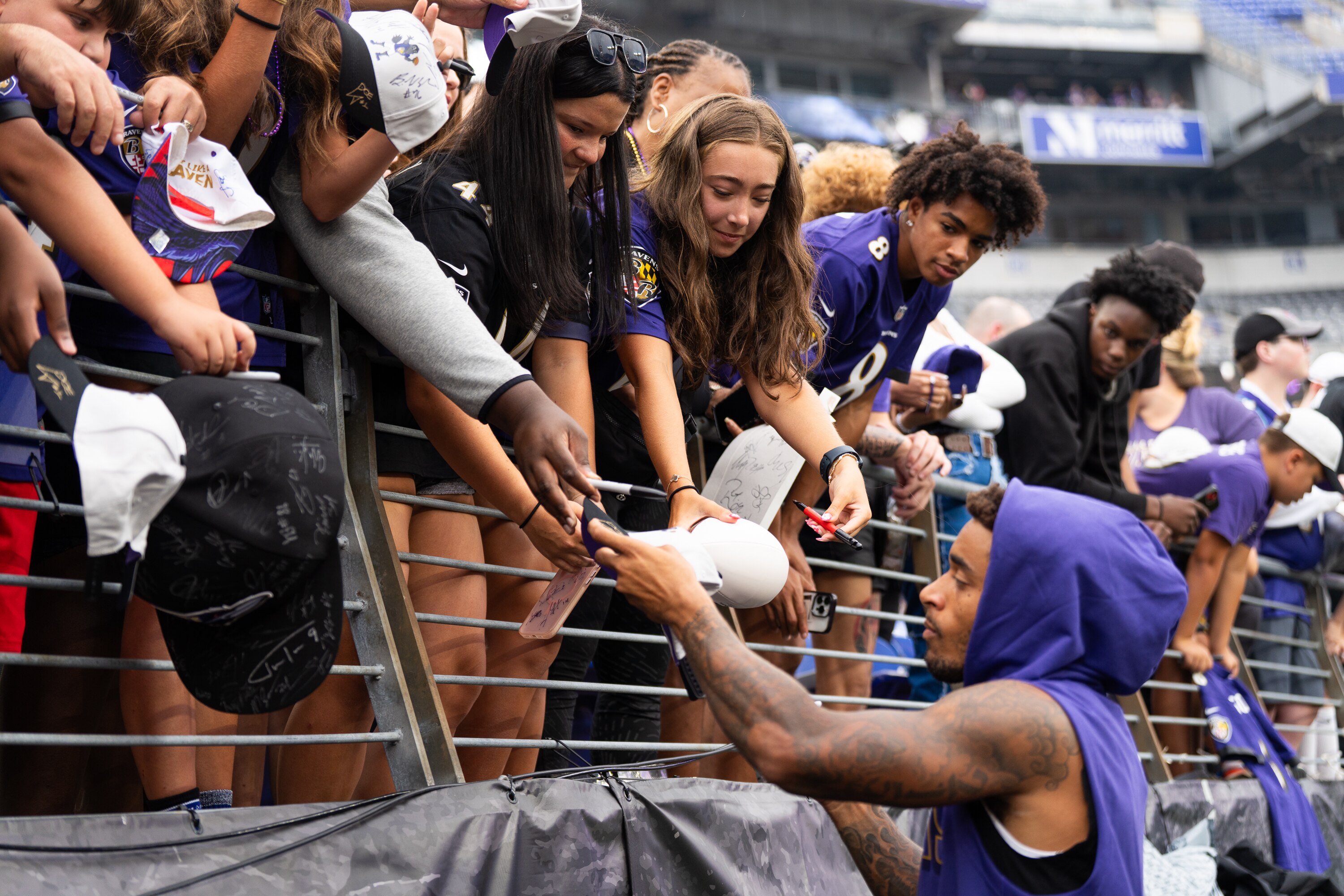 Cornerback Jaire Alexander signs autographs for fans before the Ravens hosted the Indianapolis Colts during the preseason.