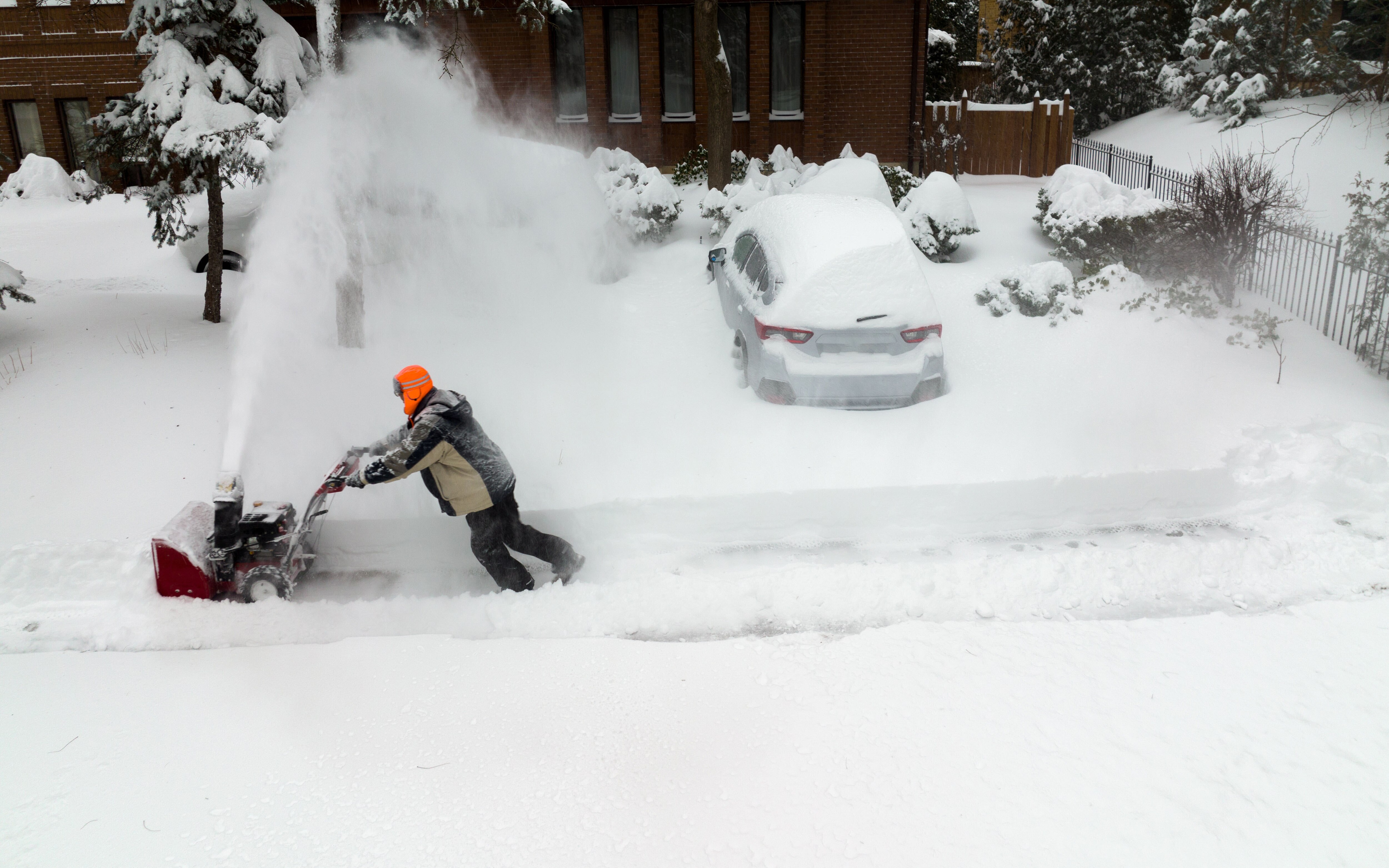 Man using snowblower in deep snow
