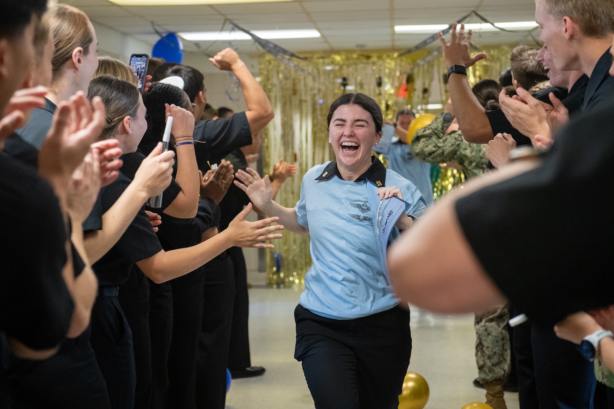 Midshipman Zoe Moore celebrates her acceptance for Navy pilot training during the annual service selection ceremony on Nov. 21, 2024 at the Naval Academy.