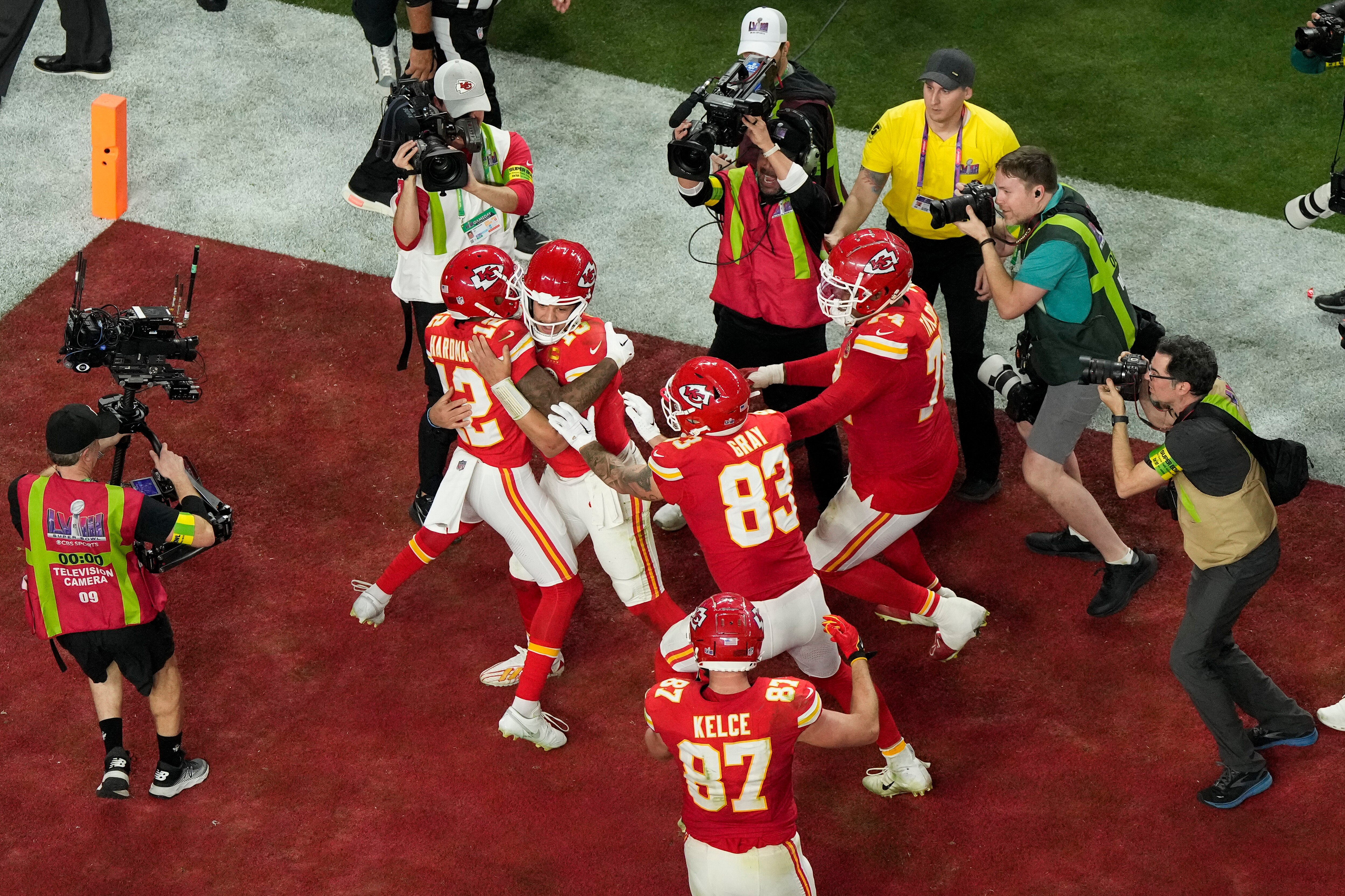 Chiefs players mob Mecole Hardman Jr. after he caught the game-winning touchdown pass in overtime.