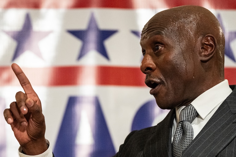 Bob Wallace speaks during his mayoral campaign launch event, pointing his finger.