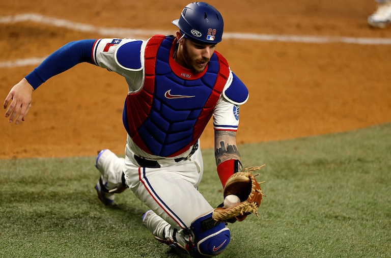 Texas Rangers catcher Jonah Heim catches a foul ball off the bat of Milwaukee Brewers first baseman Rhys Hoskins during the sixth inning on Sept. 9.