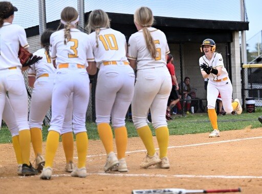 Northeast's Maddison Burris (right) celebrates with her teammates before crossing home plate after a 2-run home run in the third inning of Friday's Anne Arundel County softball match with Crofton. Burris drove in 3 runs as the No. 3 Eagles improved to 8-0 with a 5-0 victory over the fourth-ranked Cardinals in Pasadena.