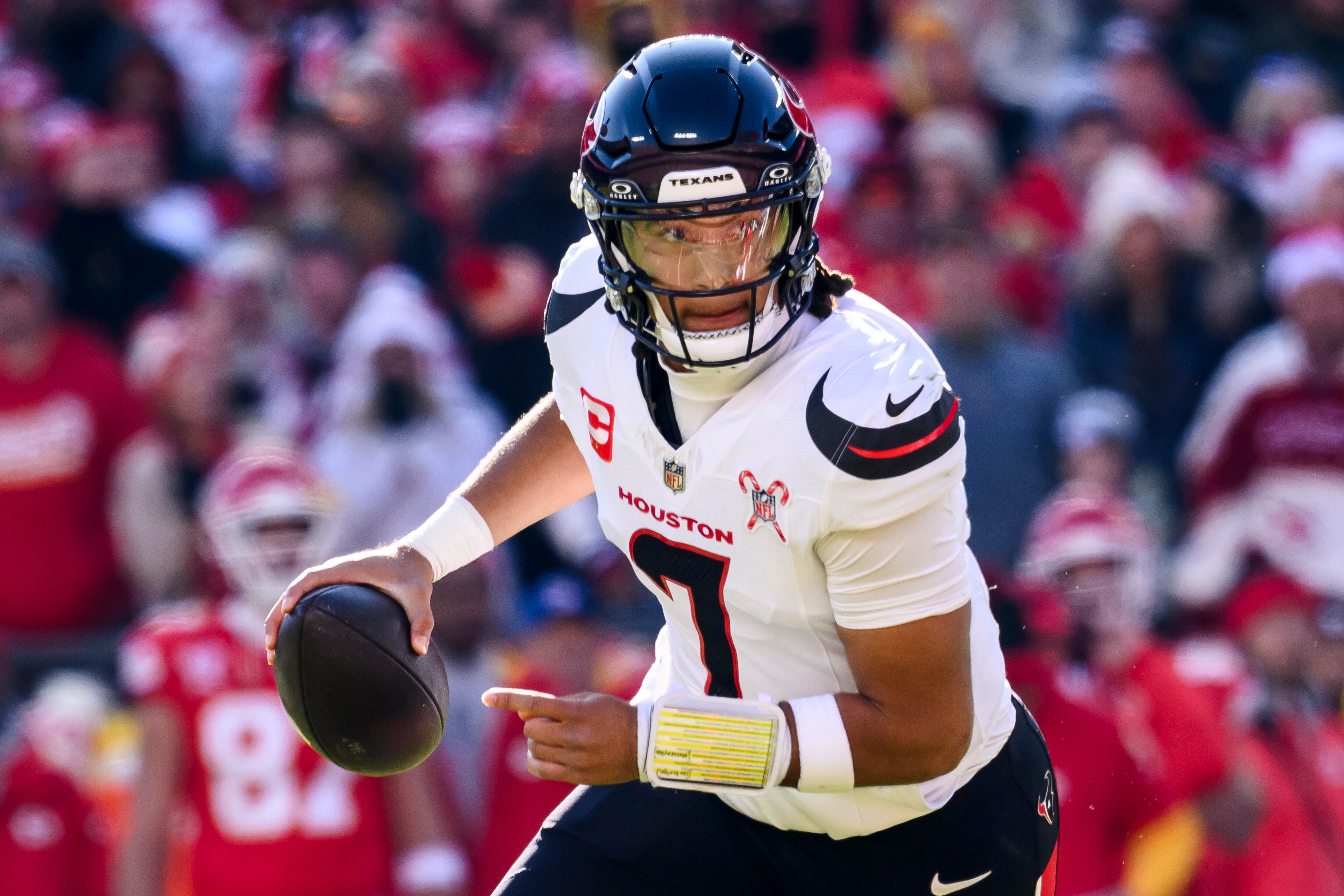 Houston Texans quarterback C.J. Stroud scrambles away from Kansas City Chiefs pressure on Saturday.