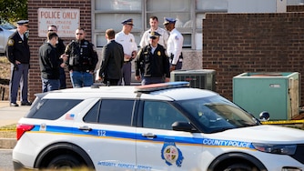 Police officers speak among themselves outside the southwest Baltimore County police precinct adjacent to the UMBC campus following a shooting at the Wilkens Police Precinct in Catonsville, Md. on Thursday, March 13, 2025.