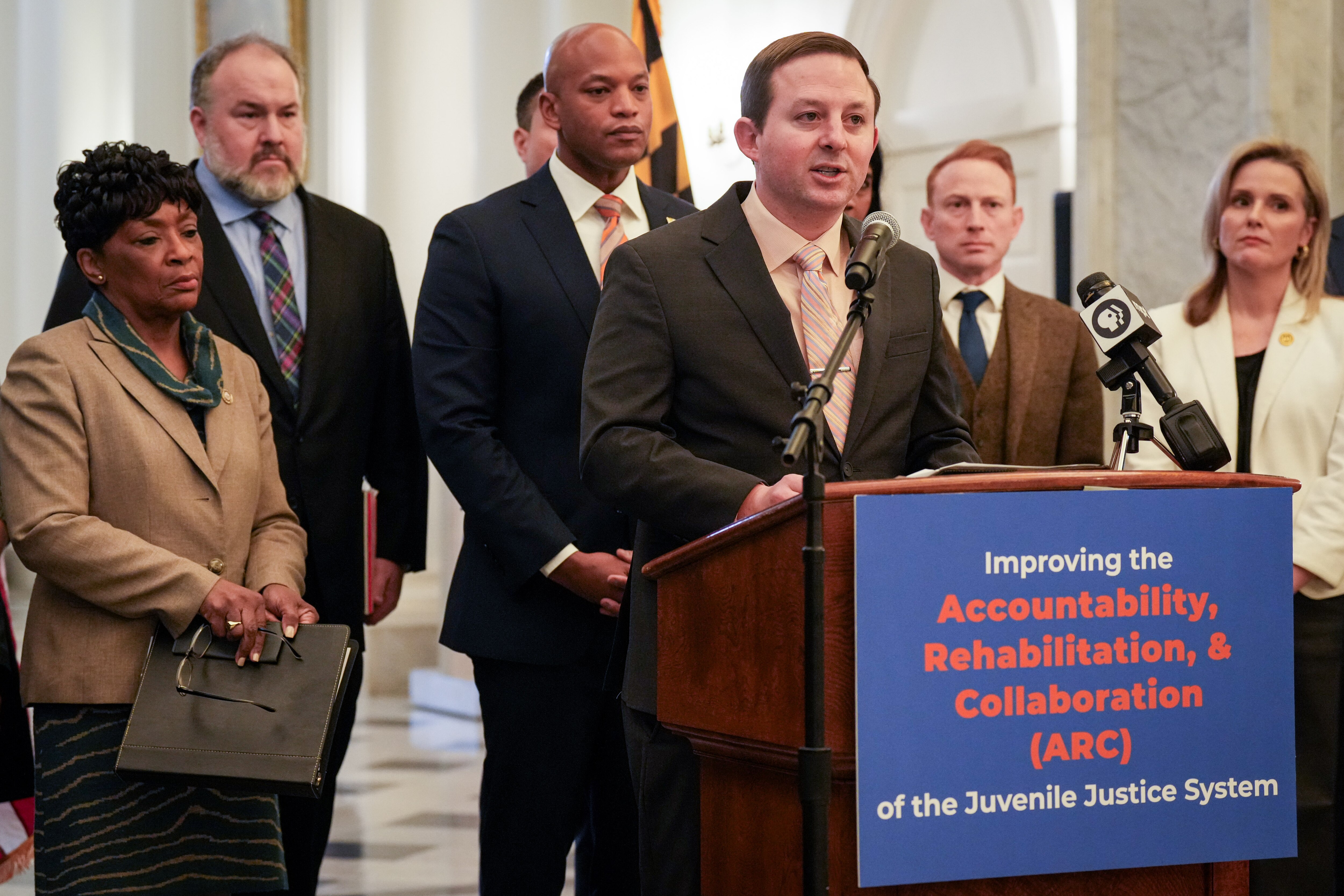 Senate President Bill Ferguson, flanked by Gov. Wes Moore as well as Maryland House and Senate leadership, announces new juvenile justice legislation in the Maryland State House lobby on Jan. 31, 2024.