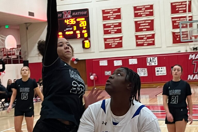 Mount Carmel's Haya Doumbouya looks to shoot the ball as Mercy's McKenzie Carroll defends during Monday evening's IAAM A Conference girls basketball contest. The No. 6 Magic moved closer to securing the fourth-seed for next week's postseason tournament with 50-34 victory on Senior Night in Northeast Baltimore.
