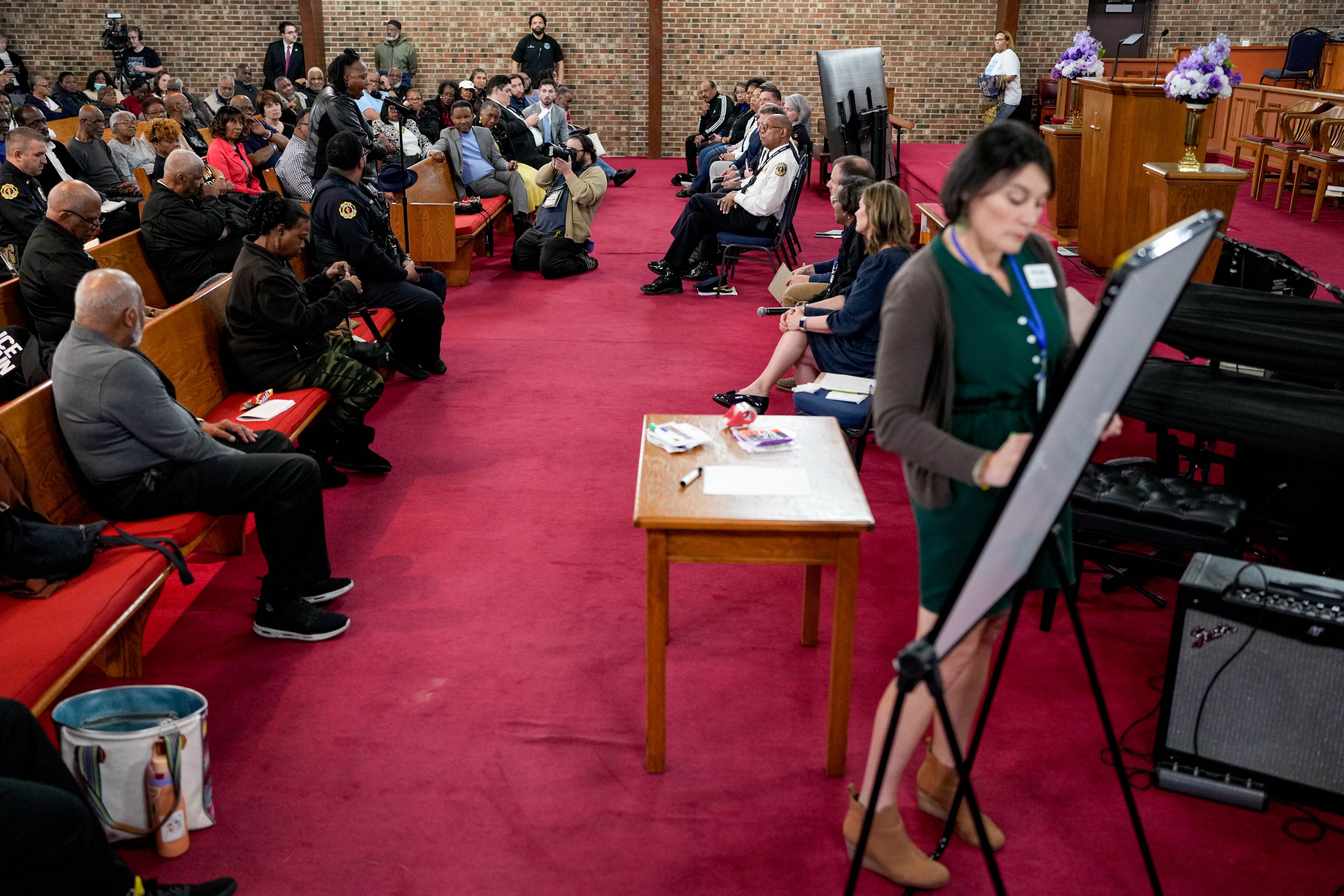 Annapolis resident Shawnte Brown, at microphone, addresses a panel of public officials during a listening session at First Baptist Church in Annapolis on Tuesday night.