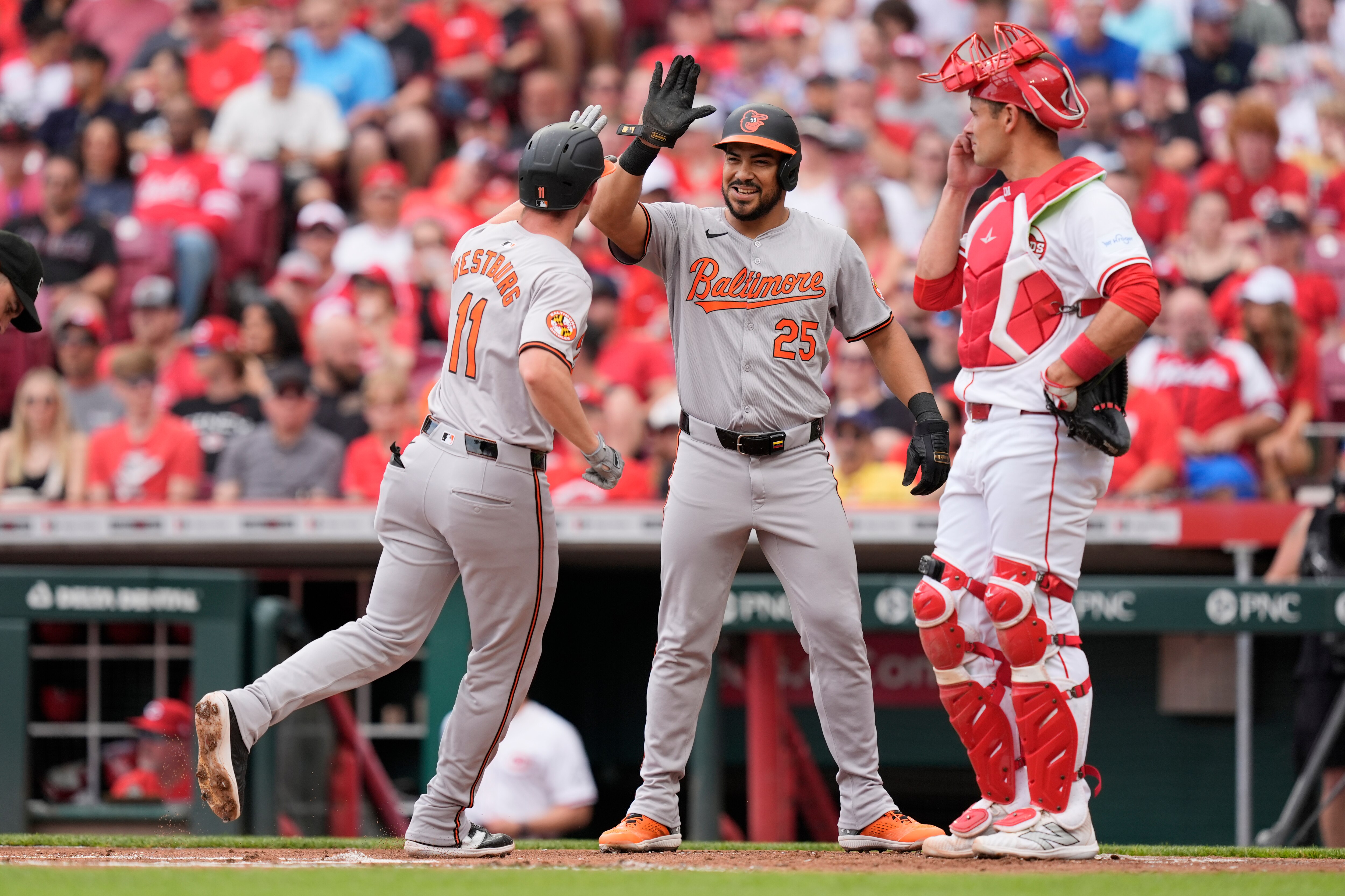 Jordan Westburg gets a high-five from Anthony Santander after a two-run, first-inning home run. Santander added a grand slam later as the Orioles won 11-1.