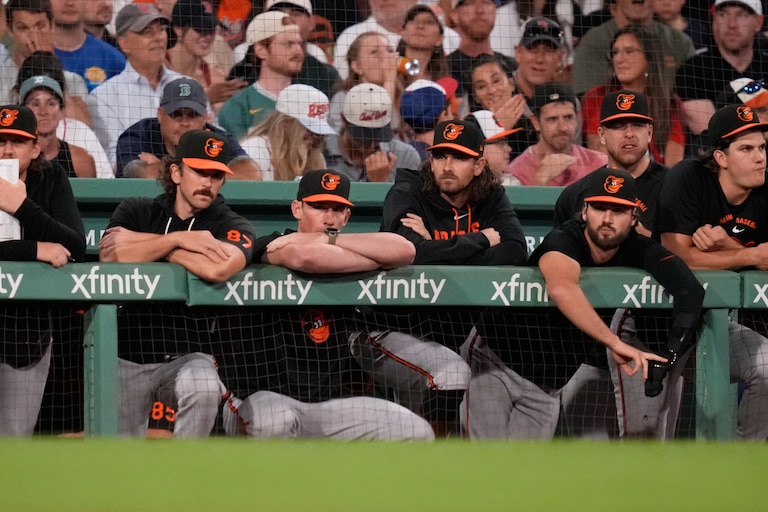 Baltimore Orioles players watch from the dugout rail after a solo home run by Boston Red Sox's Caleb Durbin in the eighth inning.