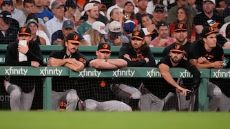 Baltimore Orioles players watch from the dugout rail after a solo home run by Boston Red Sox's Caleb Durbin in the eighth inning.